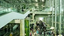 Crowd of travelers at airport terminal check-in area Stock Footage