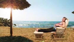 A pregnant woman sits in a rocking chair and relaxes on the beach. Stock Footage