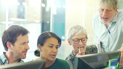 Business people meeting at computer in computer lab Stock Footage