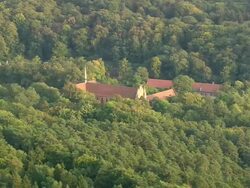 WS AERIAL View of Cistercian Monastery surrounded by trees at Chorin / Germany Stock Footage