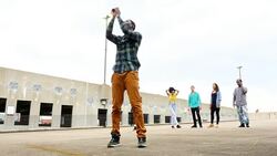 MS LA Group of friends watching man dancing in empty parking lot Stock Footage