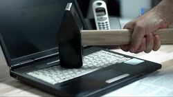 SLO MO LD Smashing the laptop with a hammer Stock Footage