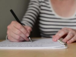 Woman writing notes in textbook Stock Footage