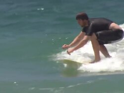 Surfers riding waves off Snapper Rocks beach News Clip