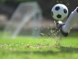 A man playing soccer on a grassy field. - Slow Motion - filmed at 240 fps Stock Footage