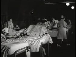 Doctors and nurses care for patients in a hospital. News Clip