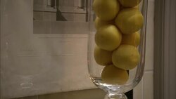 Round, yellow soaps fill a glass jar in a hotel bathroom. Stock Footage