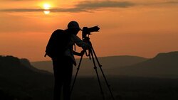 silhouette of women take a photo with mountain at sunset . Stock Footage