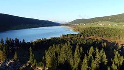 aerial view of lake and mountain in Jura Stock Footage