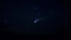 As night descends on the desert a comet crosses the star filled sky. Stock Footage