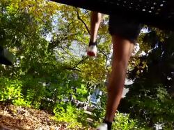 Jogger leaps a table in an urban setting Stock Footage
