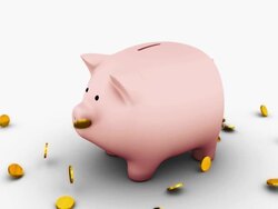 camera spins around a single piggy banks with coins falling on it Stock Footage