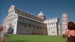 Tourists photograph the Cathedral of Pisa and the Leaning Tower of Pisa from the Piazza dei Miracoli in Italy. Stock Footage