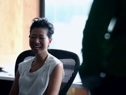 MS R/F Businesswoman sitting in office workstation in discussion with senior businessman/Washington, USA Stock Footage