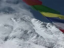 MS CU Colorful prayer flags blowing in wind beneath snowy Mt. Everest  Stock Footage