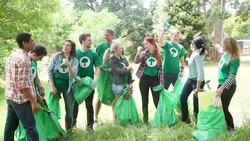 Enthusiastic environmentalist volunteers picking up trash Stock Footage