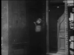 B/W 1940 soldier runs from doorway past store / London Blitz / educational Stock Footage