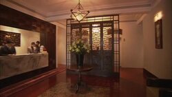 Hotel clerks work behind a reception desk in the lobby of the 88 Xintiadi Hotel in Shanghai, China. Stock Footage
