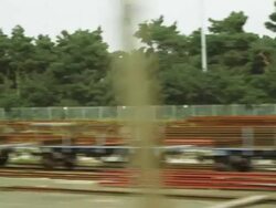 Tracking shot of stacks of pallets while riding a train Stock Footage