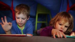 Little boy and baby girl using New Technology Stock Footage