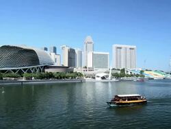 The Esplanade and Marina Bay Buildings with the Singapore Flyer Ferris wheel and River Sightseeing Boat, Singapore Stock Footage