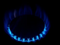 CU Shot of Blue Flame from Gas Cooker against Black background / Calvados, Normandy, France Stock Footage