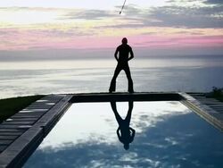WS Male poi dancer performing in front of pool with reflection of his silhouette in pool at sunrise / Montezuma, Costa Rica Stock Footage