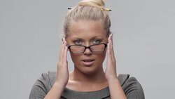 Young Beautiful Blond Woman With Glasses looking at Camera and Flirting. Stock Footage