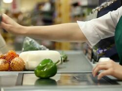 Cashier weighing and scanning items at supermarket checkout, close up Stock Footage