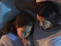 HD CRANE: Mother And Daughter Reading In Bed Stock Footage