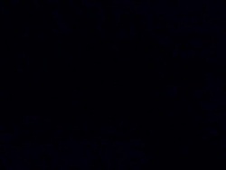 Orange triple falling into water, black background Stock Footage