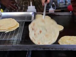 Man turning roti. Stock Footage