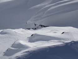 Aerial shot of ski mountaineers climbing narrow chute in Alaska Stock Footage