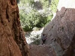 Handheld shot of a rock-climber's hesitation. Stock Footage