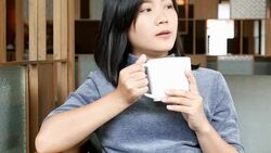 Woman drinking coffee in the morning at cafe Stock Footage