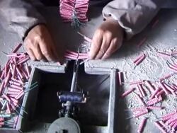 Making Fireworks Tying packs of firecrackers together Stock Footage