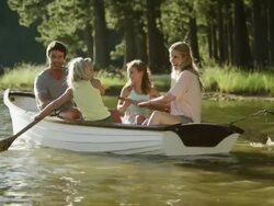 WS Pan of family rowing boat on lake Stock Footage