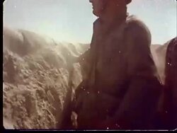 1950s MONTAGE CU Soldiers standing up in trenches and getting hit by gust of sand from shockwave of explosion at Camp Desert Rock at Nevada Test Site / Nye County, Nevada, USA Stock Footage