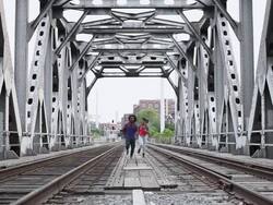MS Young male and female couple running on train track outside in urban area together having fun and smiling / Minneapolis, Minnesota, United States Stock Footage