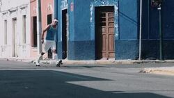 Young adult male rollerblade in urban street Stock Footage