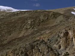 WS PAN Himalayan mountains to Tsakang Gompa Tibetan Buddhist monastery / High Himalayas, Upper Dolpo near Tibetan border, Nepal Stock Footage