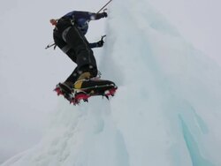 CU TU Mountain climber digging axe and clamp in ice and climbing on ice covered mountain in Austrian Alps / Stubai Glacier, Tirol, Austria  Stock Footage