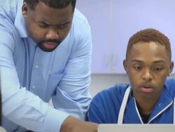 Instructor Assists Students with Laptop Computer Stock Footage