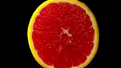 Beautiful Blood orange slowly rotating with black background Stock Footage