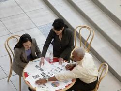 HA Business associates looking at documents on a small lobby table / Seattle, Washington, United States Stock Footage