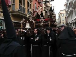 Costaleros bearing a Trono a religious float during Semana Santa, a procession through the streets of Malaga, Spain, Europe Stock Footage