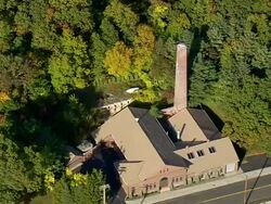 MS AERIAL ZI ZO PAN Shot of Eli Whitney Museum and covered bridge / Connecticut, United States Stock Footage