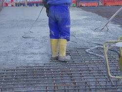 Workers Directing Concrete Onto The Construction Site Stock Footage