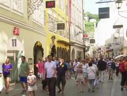 Tourists Walking in Getreidegasse (Grain Lane) in Salzburg and Passing the Birthplace of Wolfgang Amadeus Mozart Stock Footage