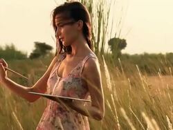 Young woman making a painting on a easel in the forest, Haryana, India Stock Footage